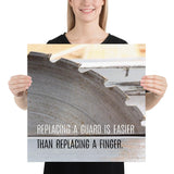 A workplace safety poster depicting a close up of a table saw blade in a workshop with a safety slogan on the bottom half of poster.