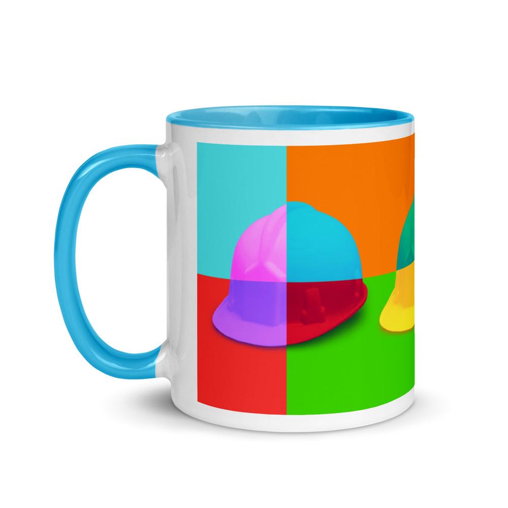 White ceramic mug with a bold hard hat pop art print with blue color on the inside, the rim, and the handle.