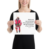 A safety poster showing a worker performing a controlled descent while wearing a fall protection harness on a bright white background with a quote from Archilochus to the right.