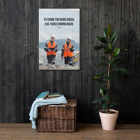 A safety poster showing two workers in reflective vests collaborating on a construction site with the proverb to know the road ahead ask those coming back.