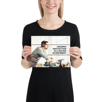 A workplace safety poster of a man in safety glasses and earmuffs taking a break in his woodshop with a safety slogan to the right.