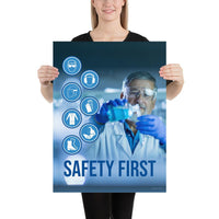 A safety poster showing a lab worker in a white coat and safety glasses conducting an experiment with infographic icons of PPE to the side and the slogan safety first.