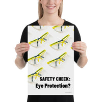 An eye safety poster depicting many clear safety glasses with yellow trim neatly lined up in rows and rows with a safety slogan in the foreground.