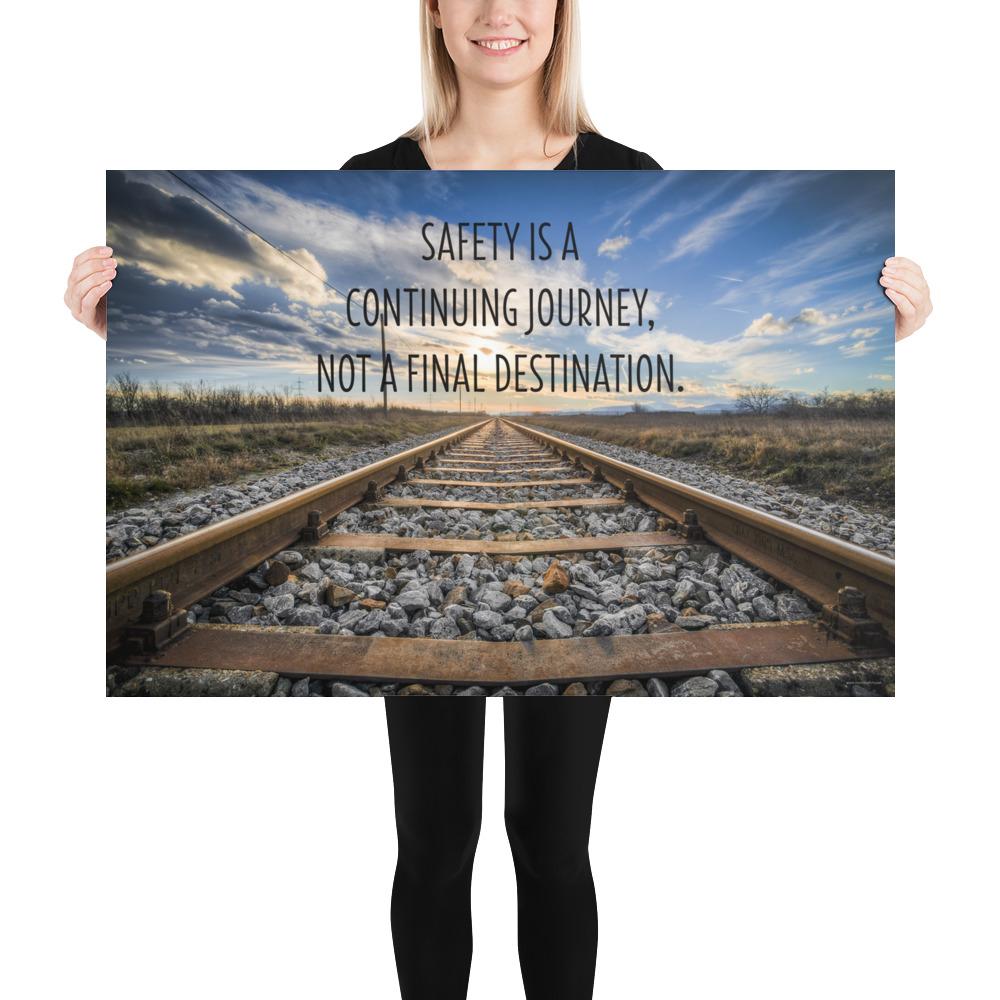 A workplace safety poster depicting old railroad tracks leading into a cloudy horizon with the text safety is a continuing journey, not a final destination.
