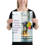 A workplace safety poster showing a construction worker wearing all of the proper PPE and bending over to work on a huge sheet of metal with sparks flying everywhere with the slogan safety is the mirror reflecting the quality of your work.