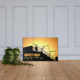A workplace safety poster showing a construction site and construction workers being silhouetted by a bright and beautiful sunset of different shades of orange with the slogan safety first, safety always.