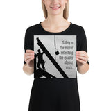 A workplace safety poster showing a construction ironworker working on a construction site with everything silhouetted black with a light grey background and with the slogan safety is the mirror reflecting the quality of your work.