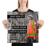 A safety poster showing a construction worker in a reflective orange vest, hard hat, and safety glasses on a construction site looking out with a safety slogan to the left.