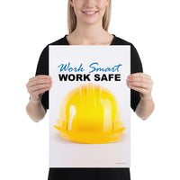 A safety poster showing a close-up of a yellow hard hat on a white background with the slogan work smart and work safe.