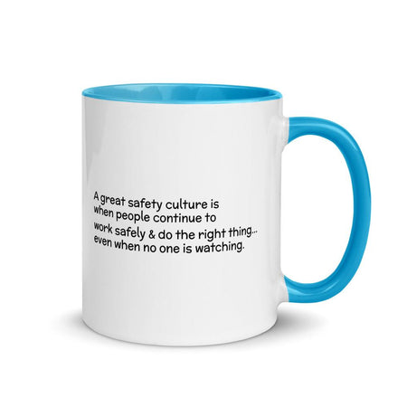 White ceramic mug with the phrase "A great safety culture is when people continue to work safely and do the right thing... even when no one is watching" in a simple black text across the side with the Inspire Safety logo on the other side, with a blue rim, inside, and handle.