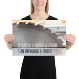 A workplace safety poster depicting a close up of a table saw blade in a workshop with a safety slogan on the bottom half of poster.