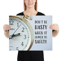 A workplace safety poster showing a close-up of a clock face with the slogan don't be hasty when it comes to safety.