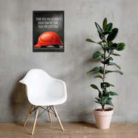 A workplace safety poster showing a bright red hard hat with an ominous black background with the slogan living with your mistakes is harder than you think, wear your safety gear.