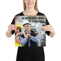 A workplace safety poster showing two workers in hardhats, reflective vests, and safety glasses collaborating together in a factory with the quote no one is wise enough by themselves by Plautus.