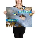 A safety poster showing a bird's-eye view of a worker in a warehouse pulling boxes on a pallet jack with the slogan work smart, work safe.
