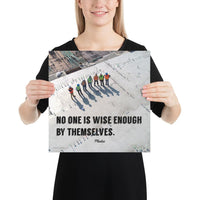 A workplace safety poster showing an aerial view of construction workers in reflective vests standing in a line on top of a building with their shadows being cast on the building with the quote no one is wise enough by themselves by Plautus.