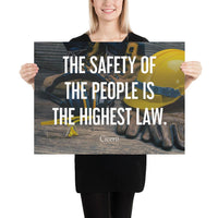 A safety poster showing a close-up of various PPE including safety glasses, ear muffs, gloves, a hard hat, and work boots with the quote by Cicero in the foreground.