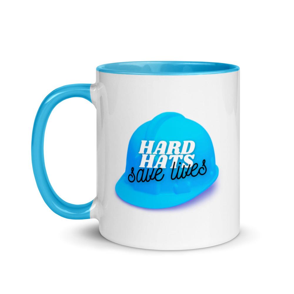 White ceramic mug with a blue hard hat with text that says "Hard hats save lives" with a blue rim, inside, and handle.