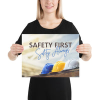 A workplace safety poster showing a white, a yellow, and a blue hardhat sitting on a wall with the slogan safety first, safety always.