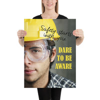Safety poster showing a close up on half of a man's face wearing a yellow hard hat and safety glasses with text to the right.