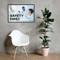 A safety poster showing two lab workers collaborating on a project in a lab while wearing full PPE with the slogan safety first.