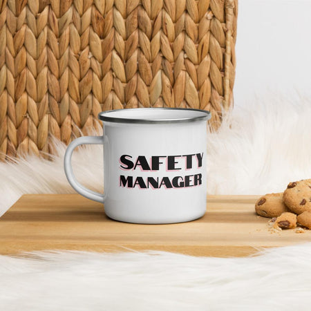 White metal mug with a silver rim with "Safety Manager" in bold text with a pink drop shadow across the side.