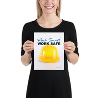 A safety poster showing a close-up of a yellow hard hat on a white background with the slogan work smart and work safe.