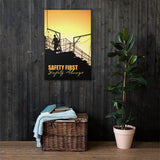A workplace safety poster showing a construction site and construction workers being silhouetted by a bright and beautiful sunset of different shades of orange with the slogan safety first, safety always.
