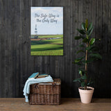 A safety poster showing an oil rig in a beautiful landscape scene of a field with vivid green grass and a bright blue sky with the slogan the safe way is the only way.