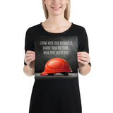 A workplace safety poster showing a bright red hard hat with an ominous black background with the slogan living with your mistakes is harder than you think, wear your safety gear.
