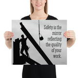 A workplace safety poster showing a construction ironworker working on a construction site with everything silhouetted black with a light grey background and with the slogan safety is the mirror reflecting the quality of your work.