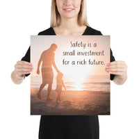 A workplace safety poster showing a father and his young daughter walking on the shore of a beach with a beautiful sunset in the background and text saying safety is a small investment for a rich future.