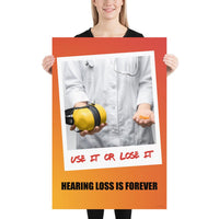 A hearing protection poster showing a doctor in a white lab coat holding out ear muffs in one hand and ear plugs in the other with a safety slogan below.