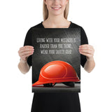 A workplace safety poster showing a bright red hard hat with an ominous black background with the slogan living with your mistakes is harder than you think, wear your safety gear.