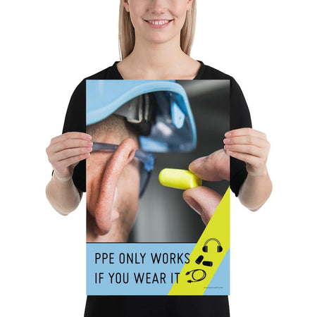 An PPE safety poster showing an extreme close up of a man wearing a blue hard hat and safety glasses plugging his ear with an ear plug with a safety slogan and infographics of hearing PPE below him.
