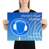 A hearing protection poster showing a bright blue construction sign with an illustration of a face wearing ear muffs with sound waves coming from the right and a safety slogan in the upper right and bottom right corners.