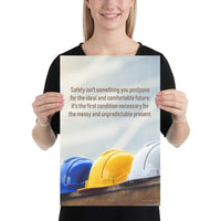 A workplace safety poster showing 3 multi colored hardhats sitting on a wall with the slogan safety isn't something you postpone for the ideal and comfortable future. It's the first condition necessary for the messy and unpredictable present.
