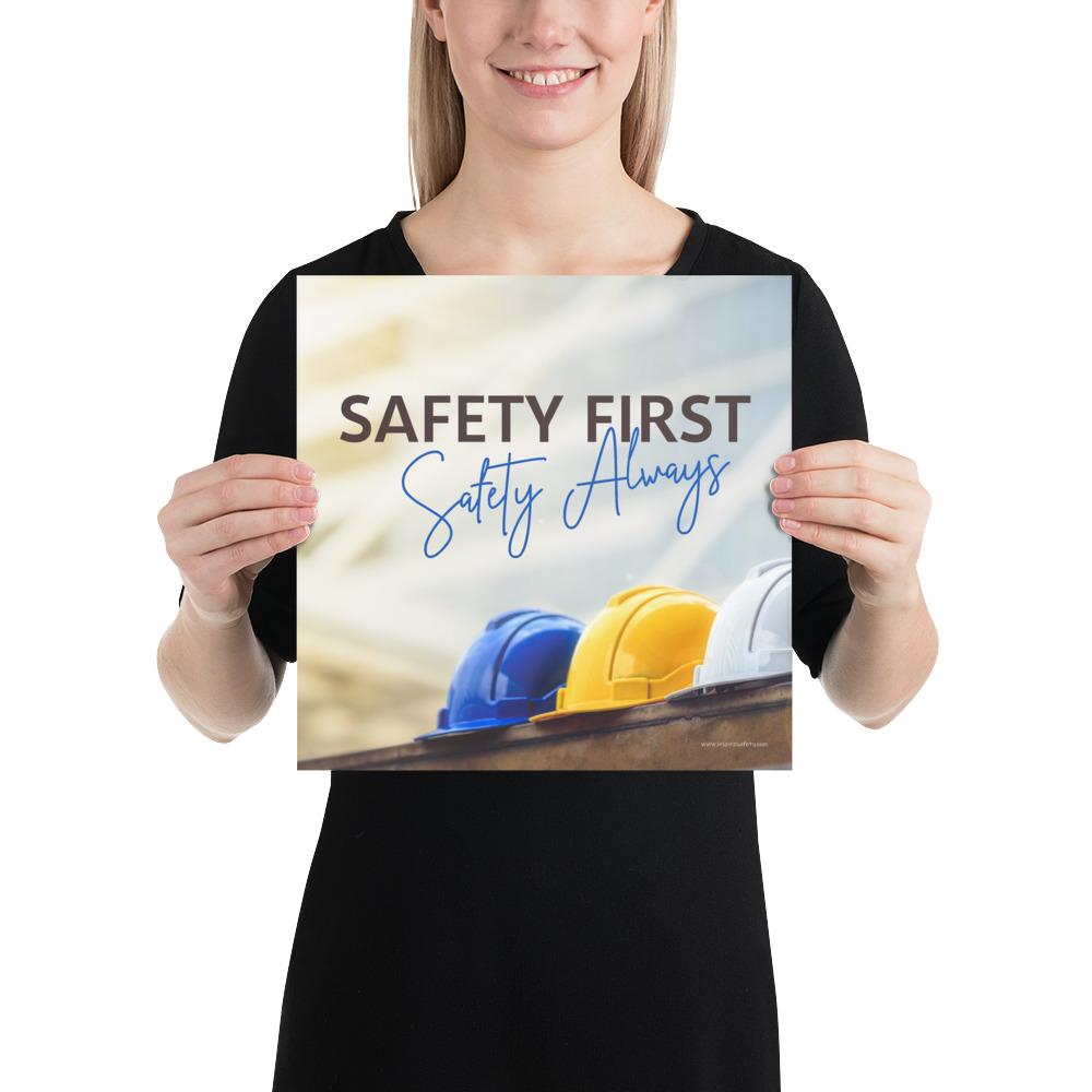 A workplace safety poster showing a white, a yellow, and a blue hardhat sitting on a wall with the slogan safety first, safety always.