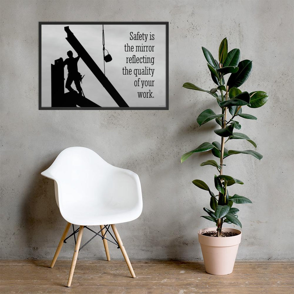 A workplace safety poster showing a construction ironworker working on a construction site with everything silhouetted black with a light grey background and with the slogan safety is the mirror reflecting the quality of your work.