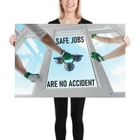 A workplace safety poster showing a close-up of two worker's hands wearing gloves while installing windows with the slogan safe jobs are no accident.