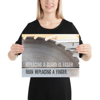 A workplace safety poster depicting a close up of a table saw blade in a workshop with a safety slogan on the bottom half of poster.