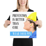 A safety poster showing a close-up of a worker wearing safety glasses, a hard hat, and earplugs with the slogan prevention is better than cure, wear your PPE.
