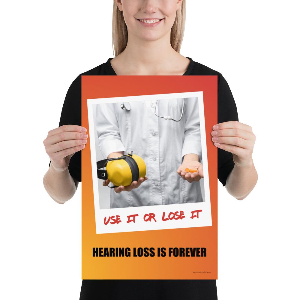 A hearing protection poster showing a doctor in a white lab coat holding out ear muffs in one hand and ear plugs in the other with a safety slogan below.