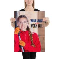 A workplace safety poster showing a warehouse worker wearing gloves and safety glasses and holding a broom and smiling with the slogan work smart and work safe.