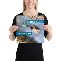 A safety poster showing a bird's-eye view of a worker in a warehouse pulling boxes on a pallet jack with the slogan work smart, work safe.
