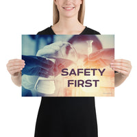 A safety poster showing a close-up of multiple gloved hands in a laboratory pouring substances into a beaker with the slogan safety first in the foreground.