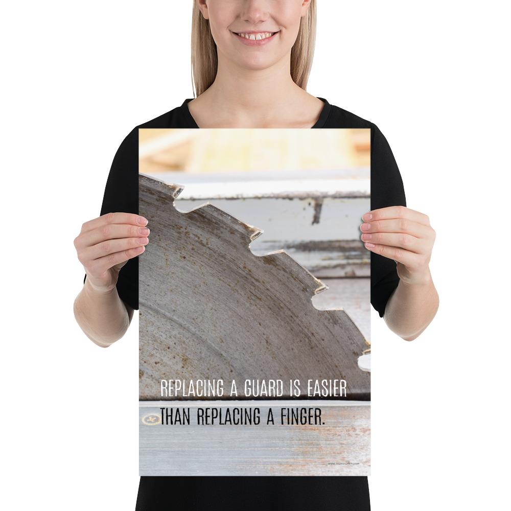 A workplace safety poster depicting a close up of a table saw blade in a workshop with a safety slogan on the bottom half of poster.