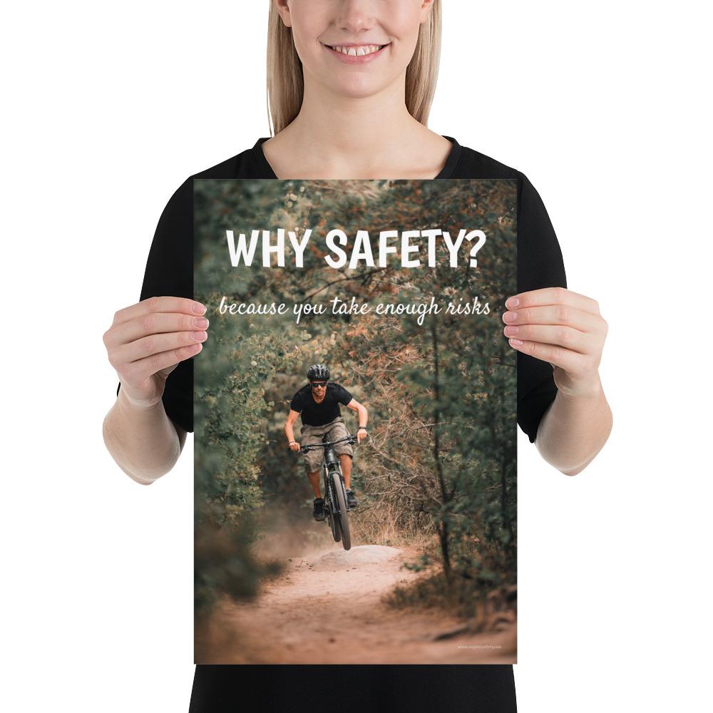 A workplace safety poster showing a man dirt biking on a forest trail with the slogan why safety? because you take enough risks.