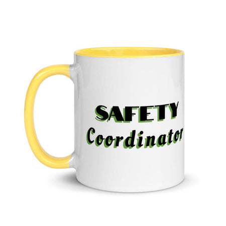 White ceramic mug with "Safety Coordinator" in bold text across the side, with yellow color on the inside, the rim, and the handle.
