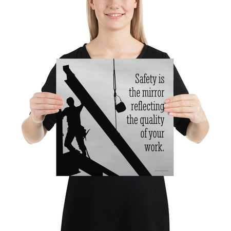 A workplace safety poster showing a construction ironworker working on a construction site with everything silhouetted black with a light grey background and with the slogan safety is the mirror reflecting the quality of your work.